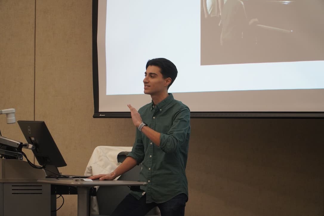 Dalton giving a talk in front of a projected slide